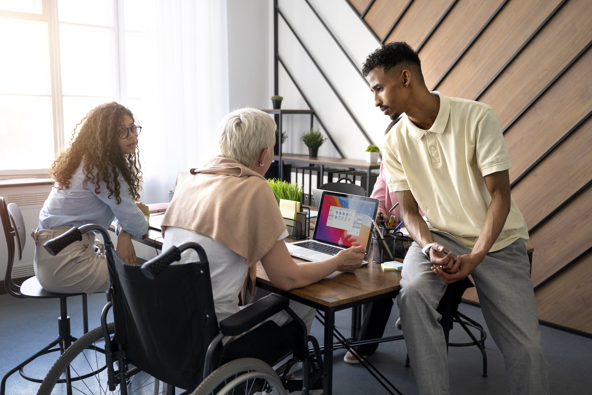 people working together at a desk people working together at a desk
